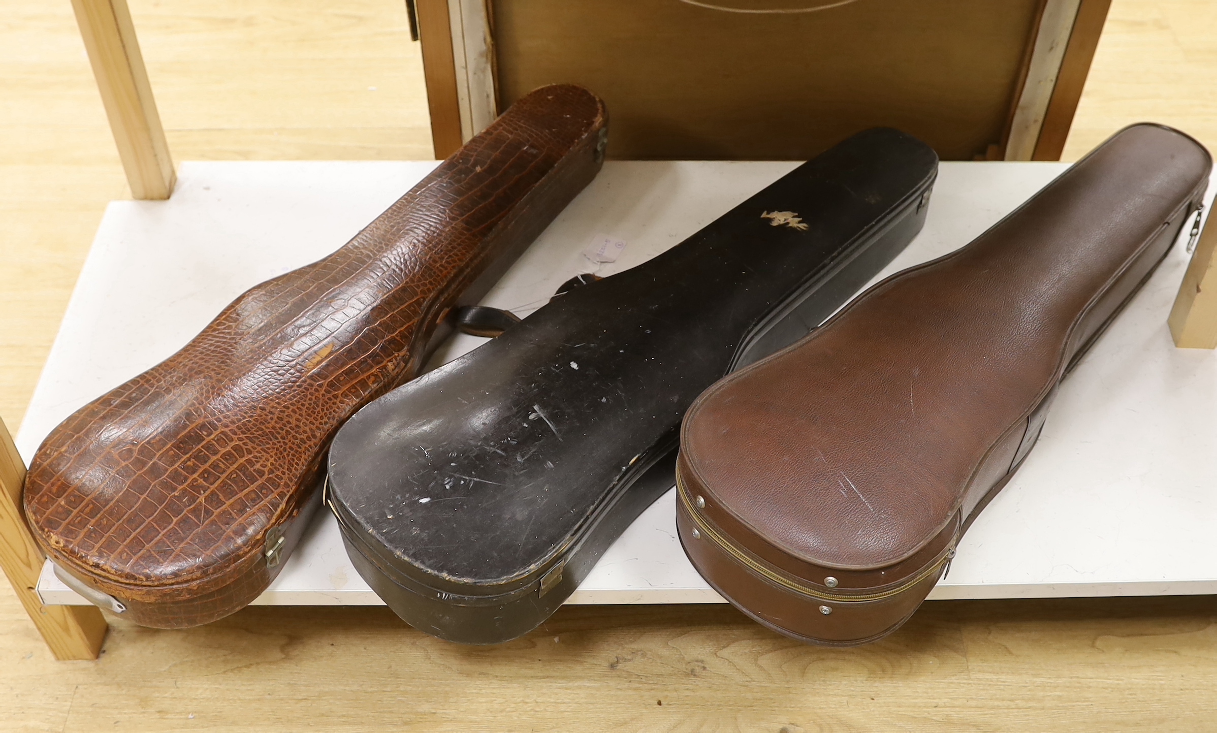 A cased 7/8 size 19th century violin, body 35cm, together with another cased violin, body 35.5cm, both without bows, and a spare case (3)